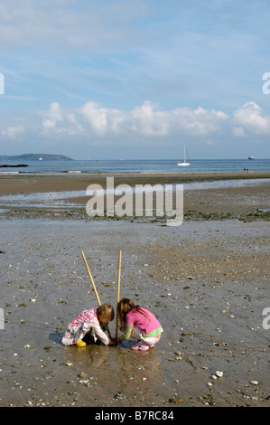 2 soeurs sur Maenporth un Cornish (UK) plage la collecte de coquillages, crabes etc. Banque D'Images