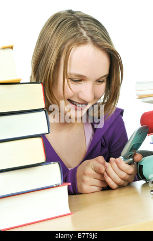 Teenage girl text messaging with cell phone in school Banque D'Images