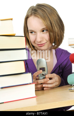 Teenage girl text messaging with cell phone in school Banque D'Images