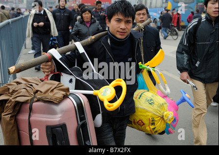 Les travailleurs migrants transporter leurs bagages de quitter la gare de Nanchang, Jiangxi, Chine. 05-Feb-2009 Banque D'Images