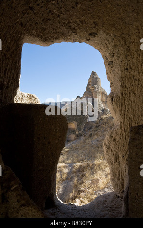 Église cachée encadré. L'église cachée encadrée par une fenêtre de l'église à coupole dans la Vallée de Soganli wonderous. Banque D'Images