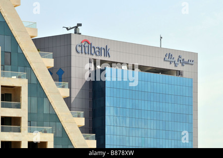 Panneaux de marque avec logo bilingue sur le toit en haut du bâtiment de bureaux Citibank de Dubaï et panneaux de revêtement en verre teinté dans les Émirats arabes Unis au Moyen-Orient Banque D'Images