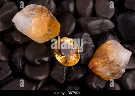 Cristal de Quartz Citrine sur noir riverstones Banque D'Images