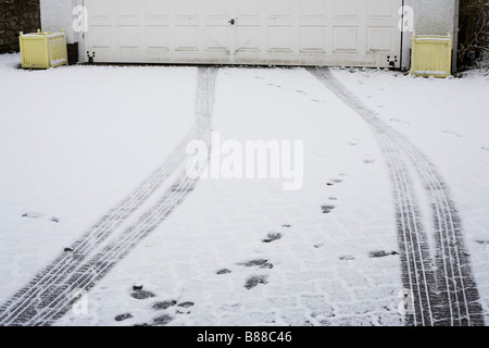 L'allée sur la colline de chape où résident a pris voiture de garage pour voiture, laissant les traces de pneus on driveway Banque D'Images