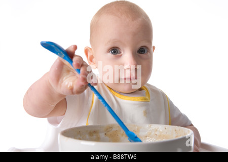 Bébé fille manger par elle-même Banque D'Images