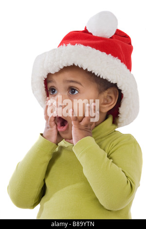 Surpris baby girl with red hat de Noël sur un over white background Banque D'Images