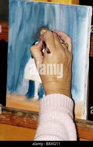 Une vieille femme mains l'image d'une jeune femme dans un studio Banque D'Images