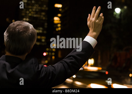 Businessman hailing a cab Banque D'Images