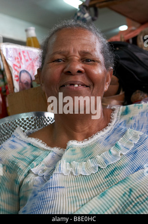 Un propriétaire de décrochage pose pour la caméra dans le marché principal à Castries, Sainte-Lucie Banque D'Images