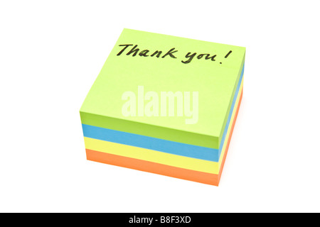 Merci écrit sur une pile de post it isolated on a white background studio Banque D'Images