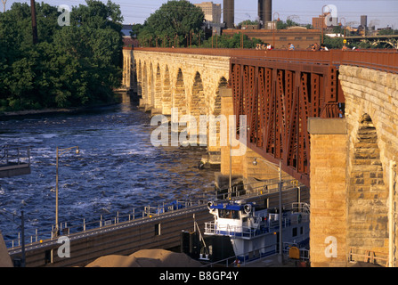 MISSISSIPPI RIVER BARGE ENTRER DANS ST. ANTHONY FALLS LOCK ET BARRAGE SOUS LE PONT EN ARC DE PIERRE. MINNEAPOLIS, Minnesota. L'été. Banque D'Images