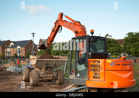 La construction de nouveaux appartements à Taunton cricket club,l'Angleterre. Jcb le chargement d'un tombereau de terre. Banque D'Images