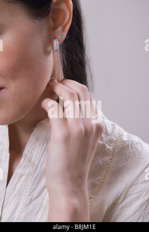 Close up of a young woman touching cou Banque D'Images