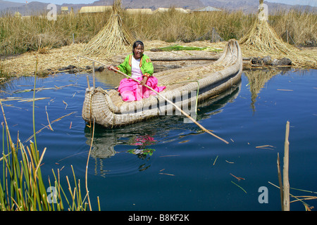 Les Indiens Uros femme Jiménez-montealegre tortora reed bateau avec les cobayes (cuy) île en arrière-plan, le Lac Titicaca, Pérou Banque D'Images