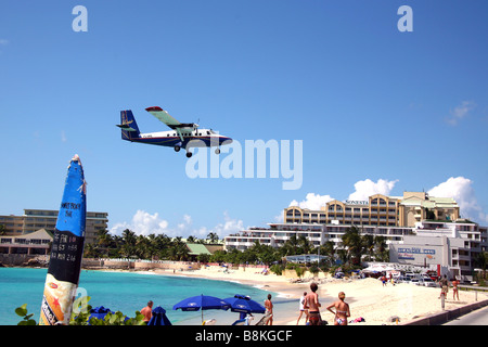 Un vol Winair atterrit sur St Maarten (St Martin). L'aéroport est célèbre pour la plage de Maho Bay avec des avions entrants faible. Banque D'Images