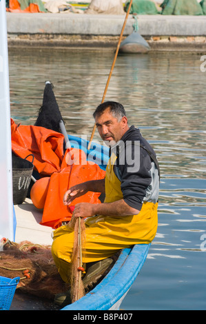 L'espagnol l'homme pêcheur réparant la réparation de ses filets de pêche Santa Pola Espagne Banque D'Images