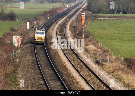 Les hommes sont la réparation des signaux ferroviaires sur une voie ferrée dans le Devon. Land Rover a leurs roues de train. Banque D'Images