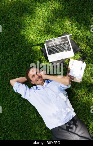 Un homme d'affaires avec un téléphone cellulaire dans un parc de la Suède. Banque D'Images