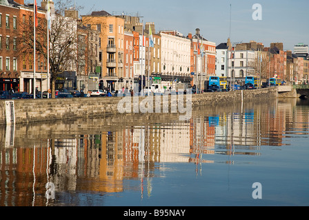 L'Irlande, Dublin. Bâtiments à quai près de Capel Street Bridge reflétée dans la rivière Liffey. Banque D'Images