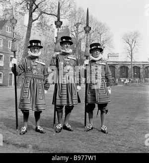 Années 1950, trois Yeoman de la Garde en robe d'État tudor pleine cérémonie debout avec des brochets, Londres, un garde du corps du monarque Briitsh. Banque D'Images