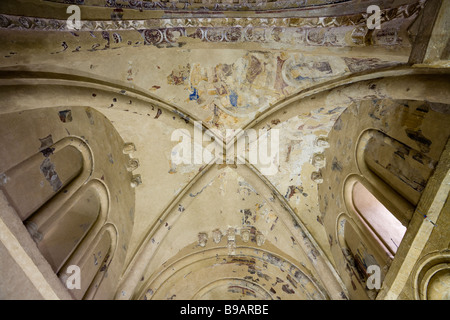 La chapelle de Carmac Plafond de l'abside. Des fragments de peintures murales romanes décorer le plafond de l'abside et des sculptures de saints chefs Banque D'Images