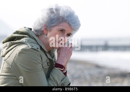 Single, lonely woman on beach, Norfolk, Angleterre Banque D'Images