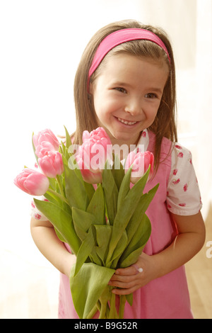5-8 ans regard caméra couleur bouquet de fleurs fleurs-rose humeur gaiement printemps printemps-fleurs printemps-cadeau bouquet heureusement Banque D'Images