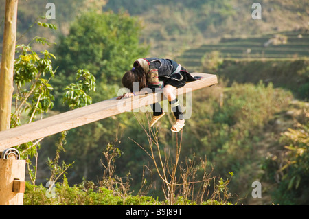 Fille Hmong noir dormir sur une balançoire à Sapa, Vietnam Banque D'Images
