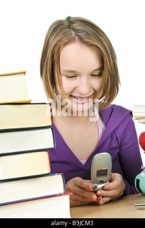 Teenage girl text messaging with cell phone in school Banque D'Images