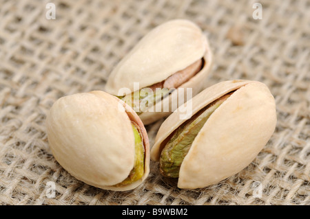 Trois pistaches sur de la toile de jute Banque D'Images