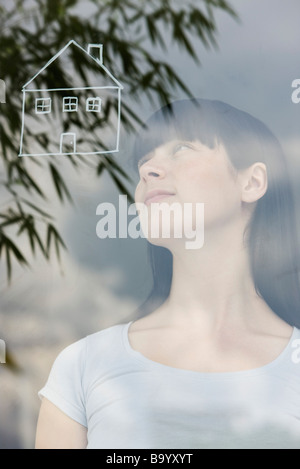 Jeune Femme rêvant d'une maison Banque D'Images