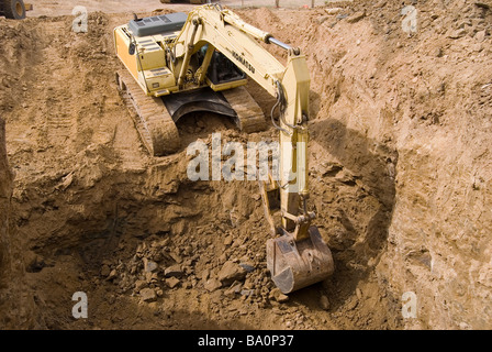 Excavatrice sur chenilles dépose de rock excavation dans le cadre d'un assainissement de l'environnement. Banque D'Images