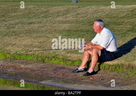 Homme de race blanche Senior citizen poissons le long de la Floride de l'étang Banque D'Images