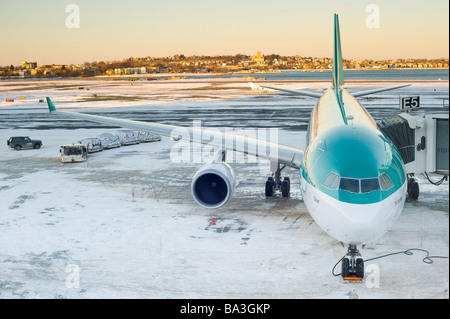 De l'avant de l'avion de passagers stationné sur la piste avec de la neige pendant le chargement déchargement. Banque D'Images