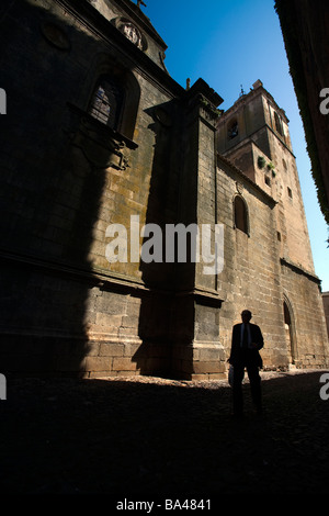 Homme marchant en face de l'église de San Mateo Caceres Espagne Banque D'Images