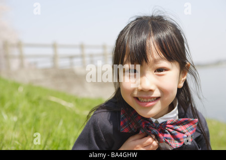 Japanese Schoolgirl smiling and looking at camera Banque D'Images