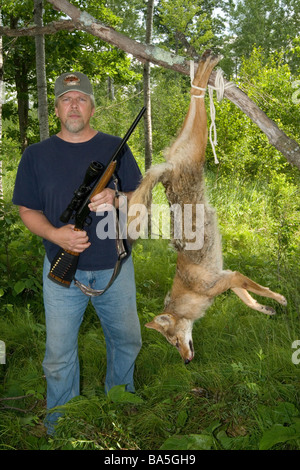 Hunter pose avec coyote récoltés Banque D'Images