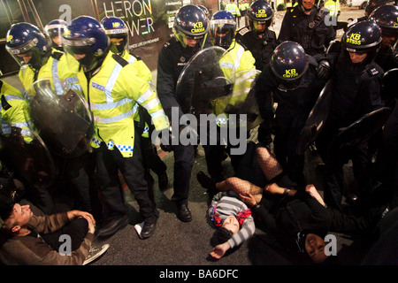 La police est la dispersion avec force les gens au G20 de démonstration dans le centre de Londres à l'aide de protections court pour frapper et pousser les gens Banque D'Images