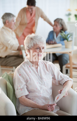 Senior woman reading carte de souhaits Banque D'Images