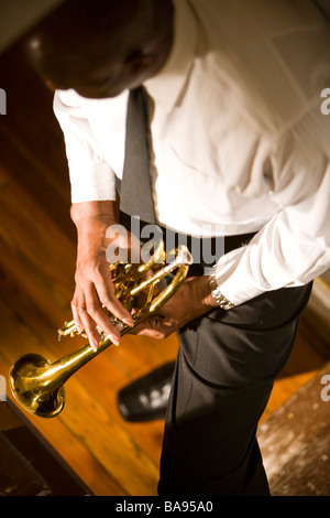 High angle view of African American musician holding Trumpet in hallway Banque D'Images