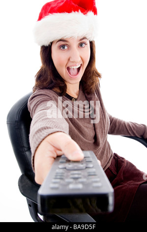 Woman in christmas hat holding remote control Banque D'Images
