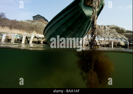 Vue de la côte suédoise, petit bateau à rames, au-dessus et au-dessous de l'eau, Halland, Suède Banque D'Images