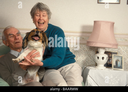 Vieux couple heureux avec leur chien bâtard Banque D'Images