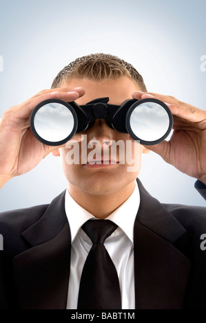 Young businessman using binoculars Banque D'Images