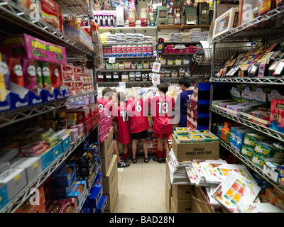 Les enfants au guichet à un magasin de bonbons dans le Lower East Side de New York. Banque D'Images