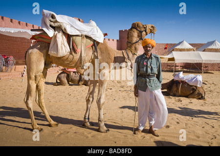 L'homme debout à côté d'un chameau, le chameau d'Osian, Camp Osian, Rajasthan, Inde Banque D'Images