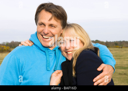 Un beau 40 fils de câlins jusqu'à sa belle mère des années 60 au cours d'une journée dans la campagne. Banque D'Images