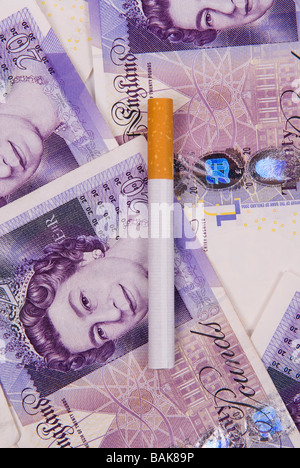 Cigarette sur un tas d'argent Banque D'Images