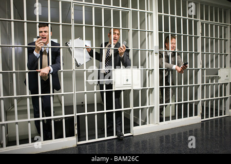 Les hommes d'affaires en prison Banque D'Images