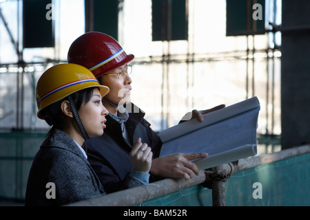 Des entrepreneurs en construction Site Wearing hard hats Banque D'Images